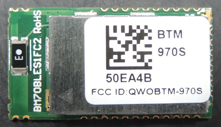 The BTM-970S module is shown with product ID sticker on it. Underneath the product ID the FCC ID is clearly listed