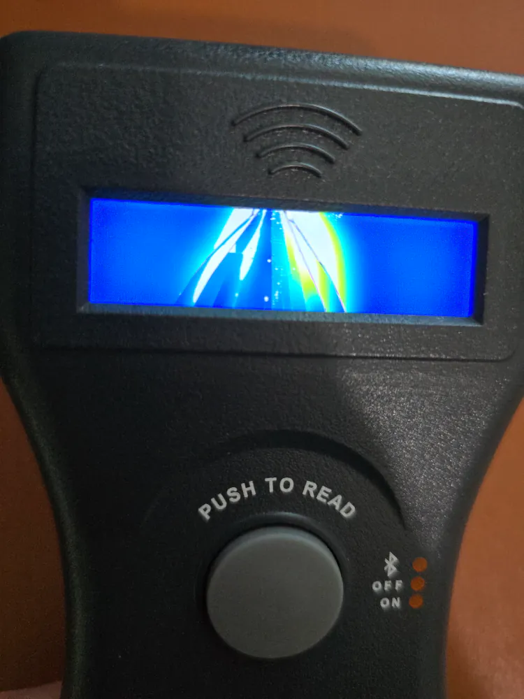 photo of front of device with screen visible cracked and showing no text while on.