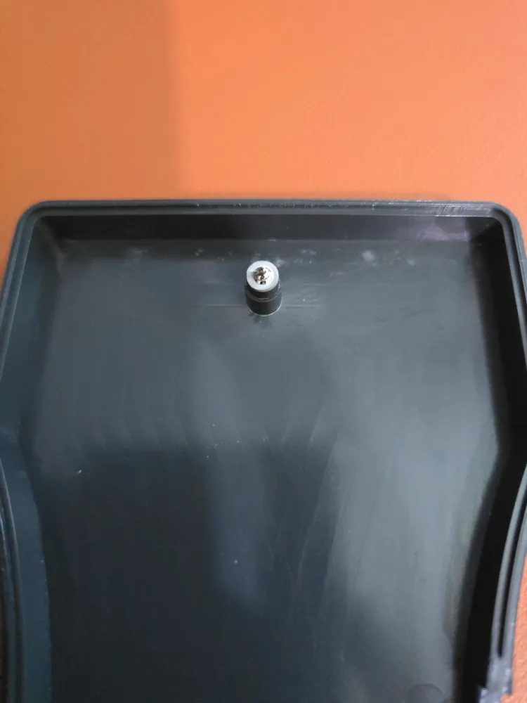 inside of bottom half shown, with the boss having a tip of screw visible