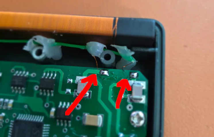 photo of internal printed circuit board (PCB) and wire coil. The wires are not soldered to PCB.