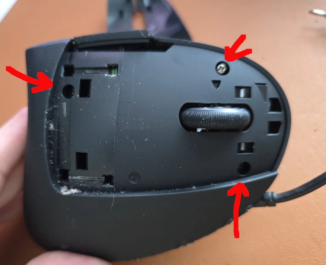 Top of mouse, with the main mouse buttons removed to reveal 3 screw locations noted with arrows.